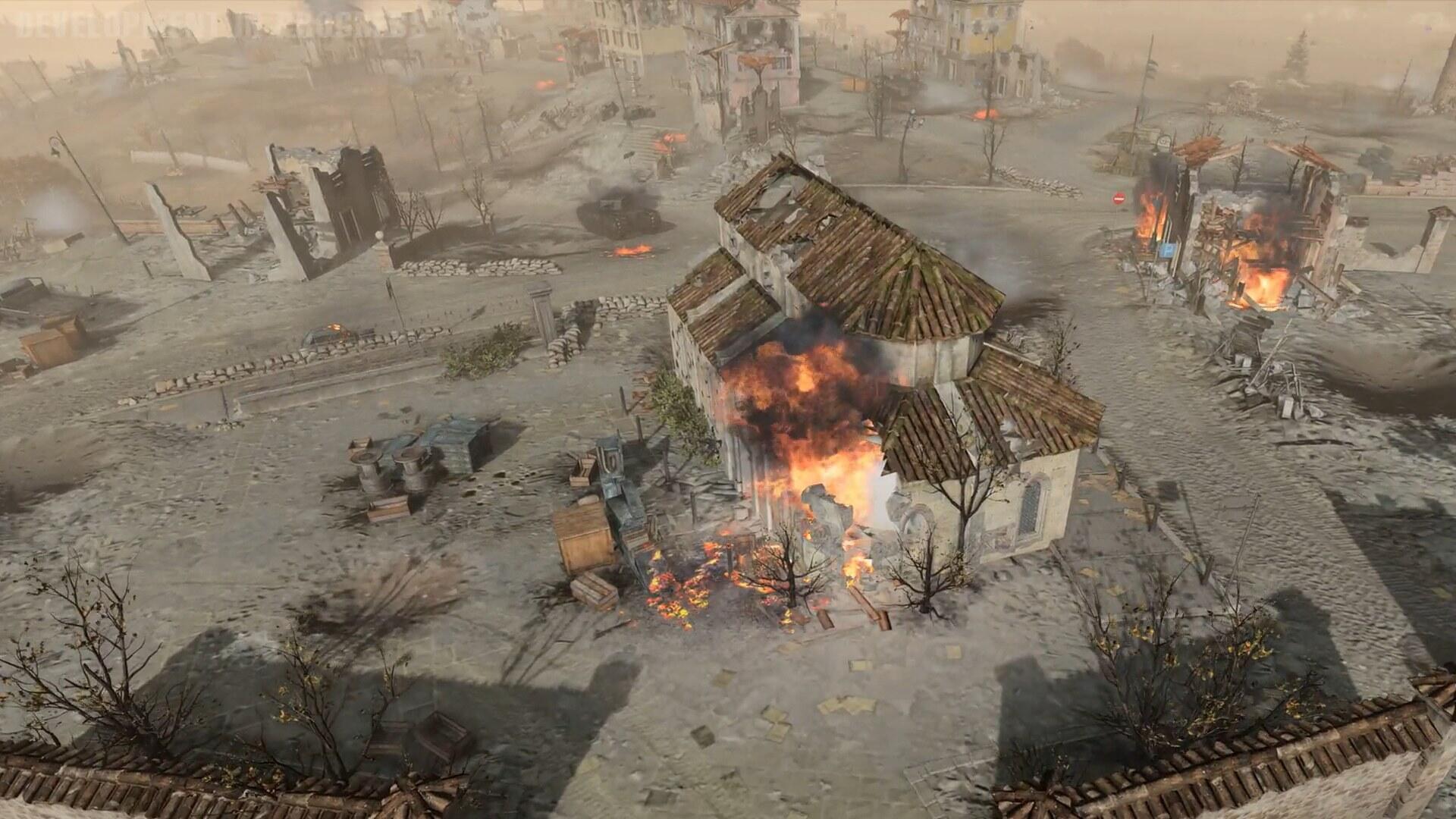 Screenshot di gameplay in Company of Heroes 3 che mostra uno scontro tra carri armati e postazioni fortificate.