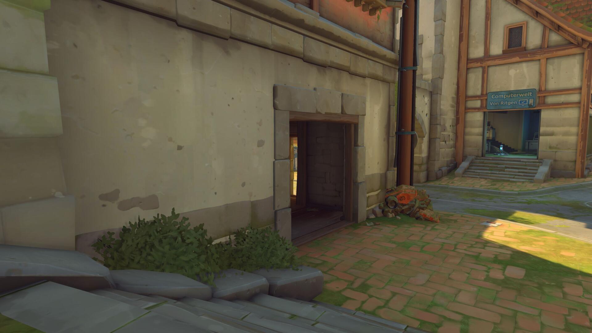 Screenshot in-game della mappa Eichenwalde in Overwatch con la correzione della linea di tiro presso la prima strettoia.
