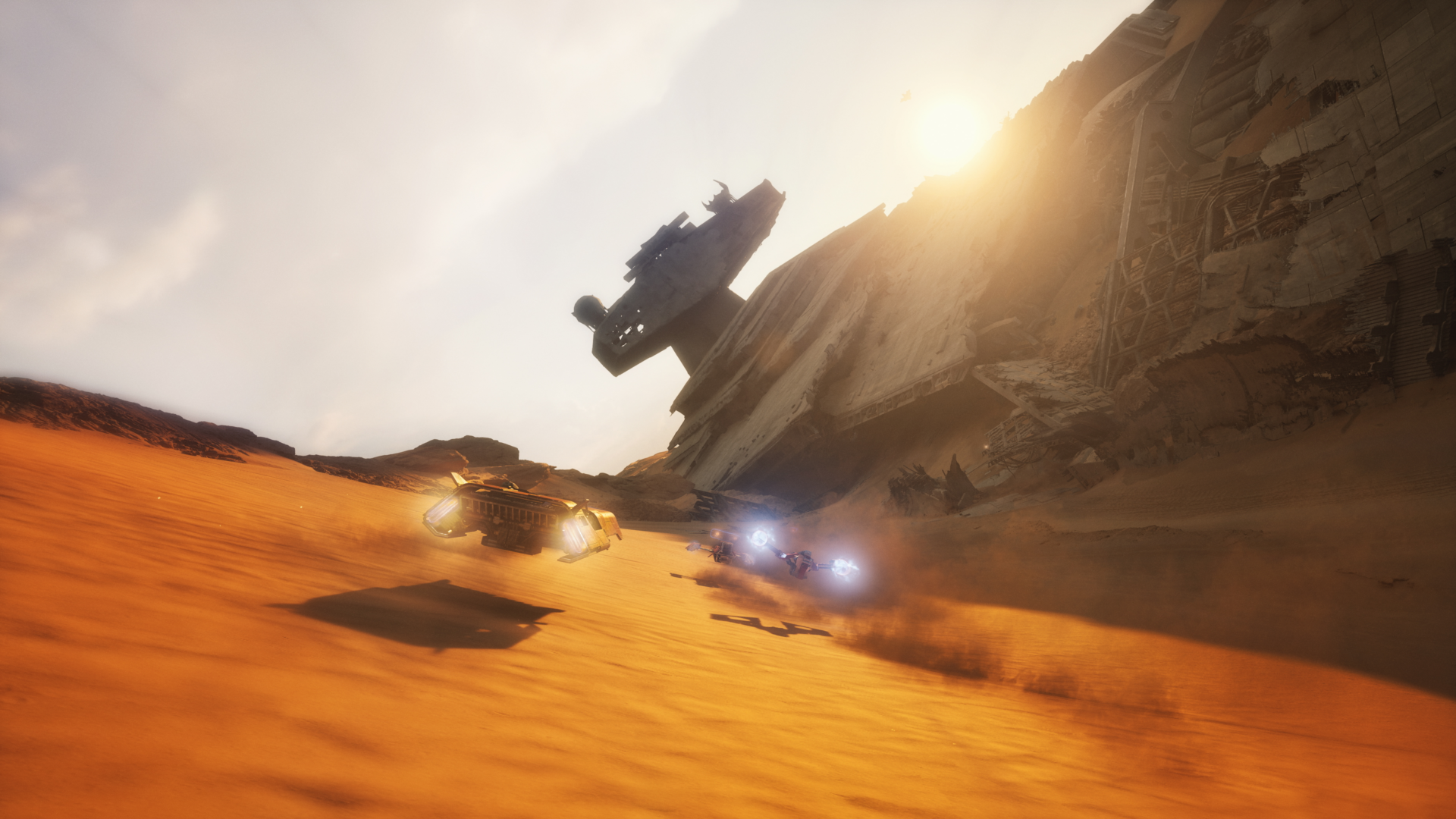 Screenshot in-game di Star Wars: Galactic Racer ambientato sul pianeta desertico Jakku, tra relitti di Star Destroyer abbattuti e AT-AT.